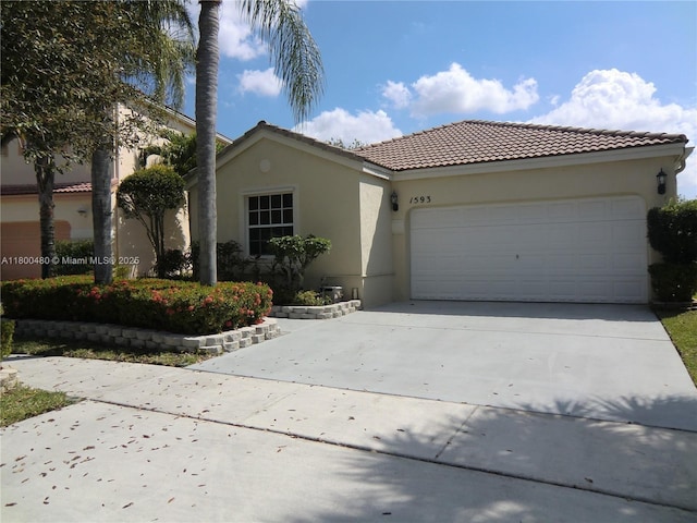 1593 NW 158th Ave, Pembroke Pines, FL 33028 - view of front of house with driveway, a garage, stucco siding, and a tile roof