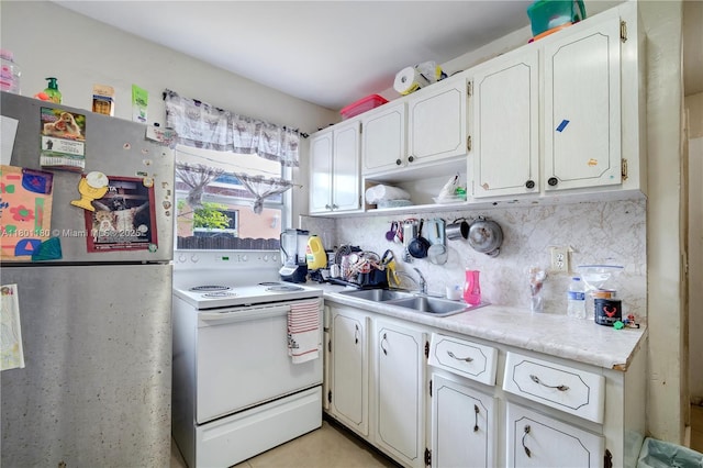 3050 NW 22nd Ct, Miami, FL 33142 - kitchen featuring freestanding refrigerator, electric stove, a sink, light countertops, and backsplash