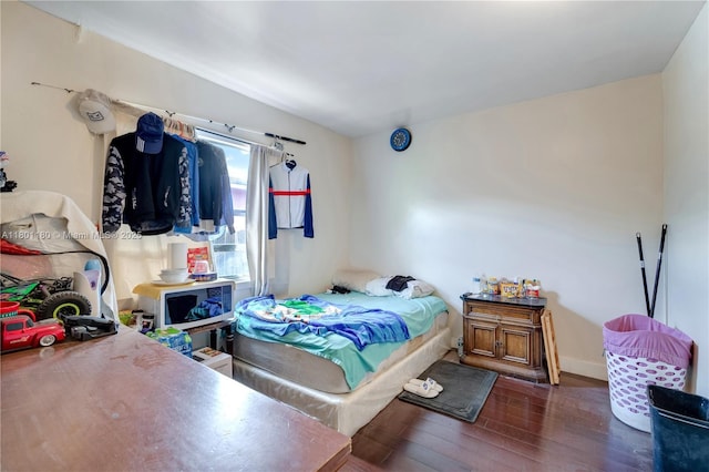3050 NW 22nd Ct, Miami, FL 33142 - bedroom featuring wood-type flooring and baseboards