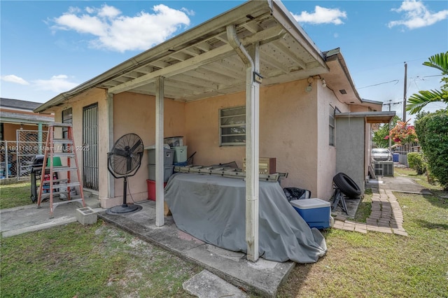3050 NW 22nd Ct, Miami, FL 33142 - rear view of house featuring stucco siding and a lawn
