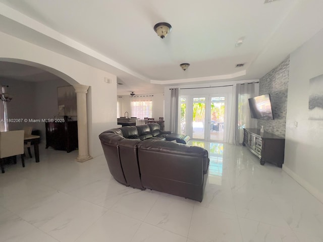 19994 SW 129th Ct, Miami, FL 33177 - living room with decorative columns, arched walkways, a tray ceiling, and light marble finish floors