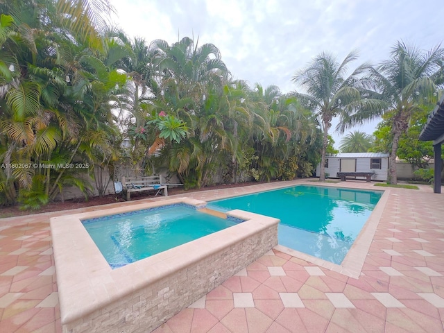 19994 SW 129th Ct, Miami, FL 33177 - view of pool featuring a patio area, an outbuilding, and a pool with connected hot tub