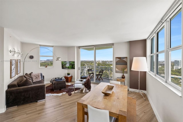 2475 Brickell Ave Unit 2002, Miami, FL 33129 - dining room featuring healthy amount of natural light, light wood finished floors, and baseboards