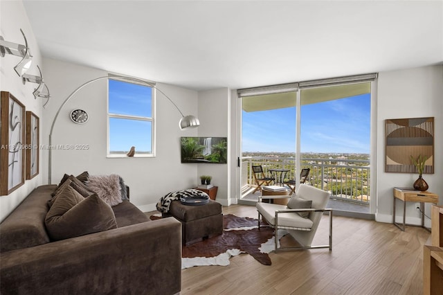 2475 Brickell Ave Unit 2002, Miami, FL 33129 - living area featuring wood finished floors, floor to ceiling windows, and baseboards