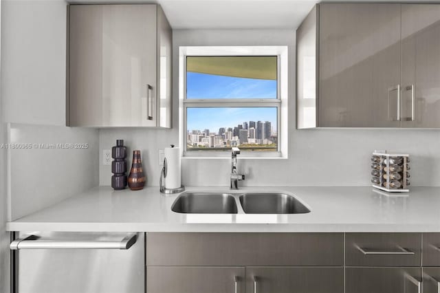 2475 Brickell Ave Unit 2002, Miami, FL 33129 - kitchen with stainless steel dishwasher, a sink, light countertops, gray cabinets, and modern cabinets