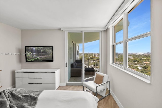 2475 Brickell Ave Unit 2002, Miami, FL 33129 - bedroom with access to outside, light wood-style flooring, and baseboards