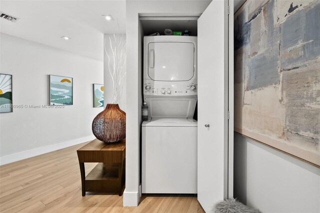 2475 Brickell Ave Unit 2002, Miami, FL 33129 - washroom featuring stacked washer / drying machine, wood finished floors, recessed lighting, and baseboards