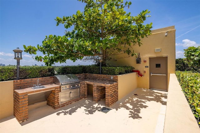 2475 Brickell Ave Unit 2002, Miami, FL 33129 - view of patio featuring grilling area, an outdoor kitchen, and a sink
