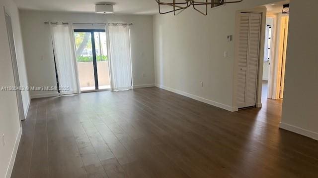 spare room with wood finished floors and baseboards