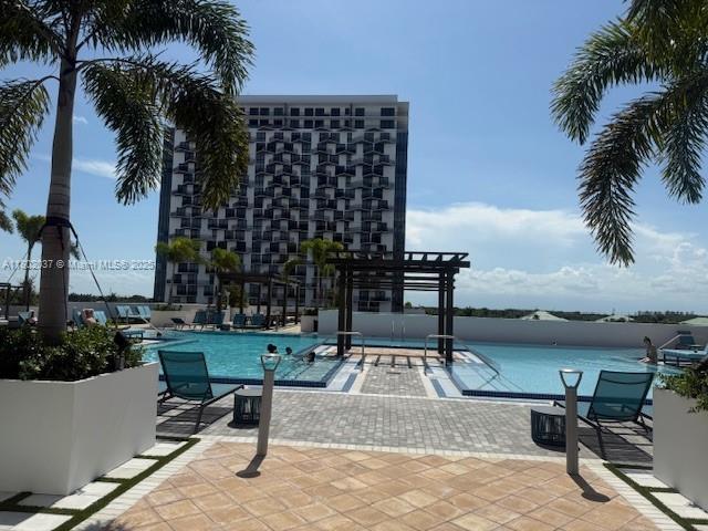 5350 NW 84th Ave Unit 1207, Doral, FL 33166 - community pool featuring a pergola and a patio