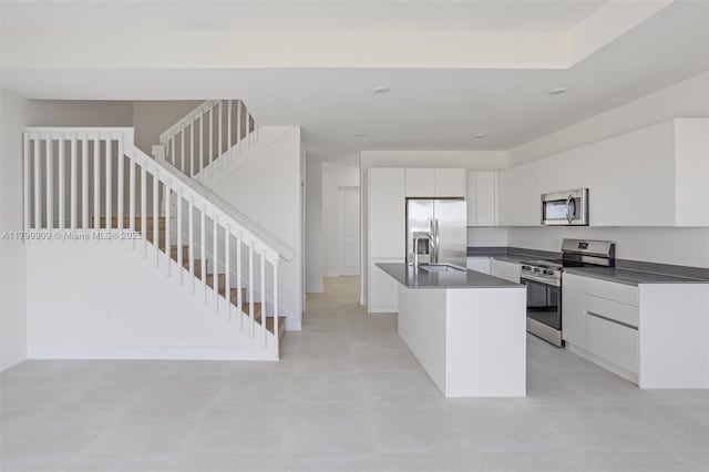 18953 SW 344th Ter, Homestead, FL 33034 - kitchen featuring stainless steel appliances, dark countertops, a sink, a center island with sink, and modern cabinets