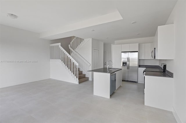 18953 SW 344th Ter, Homestead, FL 33034 - kitchen featuring appliances with stainless steel finishes, dark countertops, a kitchen island with sink, and open floor plan