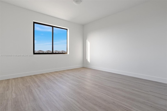 18953 SW 344th Ter, Homestead, FL 33034 - spare room featuring baseboards and wood finished floors