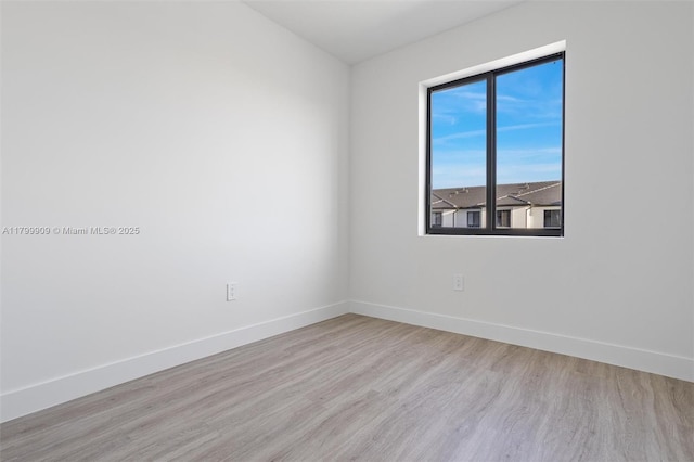 18953 SW 344th Ter, Homestead, FL 33034 - empty room with wood finished floors and baseboards
