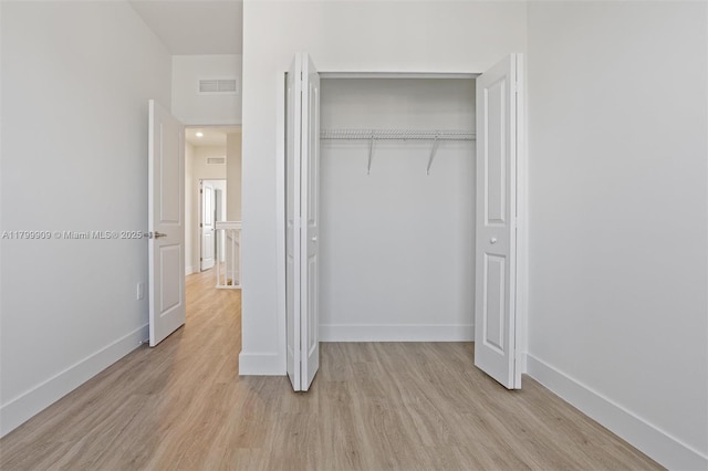 18953 SW 344th Ter, Homestead, FL 33034 - unfurnished bedroom featuring light wood-style flooring, a closet, and baseboards