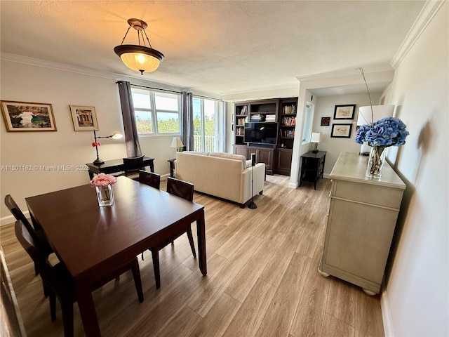 16518 NE 26th Ave Unit 405, North Miami Beach, FL 33160 - dining room with ornamental molding, light wood-type flooring, a textured ceiling, and baseboards