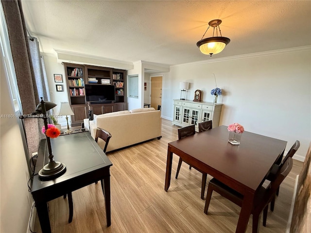16518 NE 26th Ave Unit 405, North Miami Beach, FL 33160 - dining room featuring crown molding, light wood-type flooring, and a textured ceiling