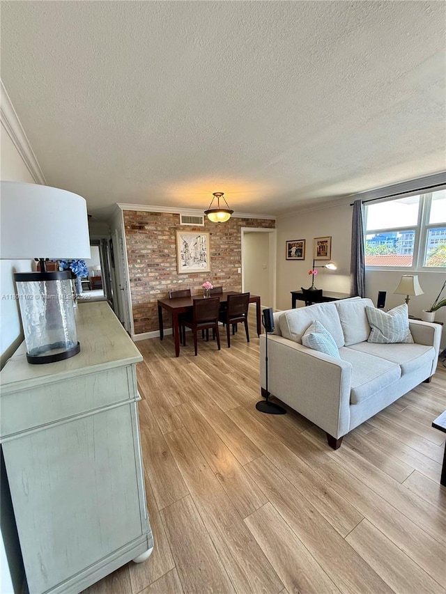 16518 NE 26th Ave Unit 405, North Miami Beach, FL 33160 - living room with a textured ceiling, light wood-type flooring, and ornamental molding