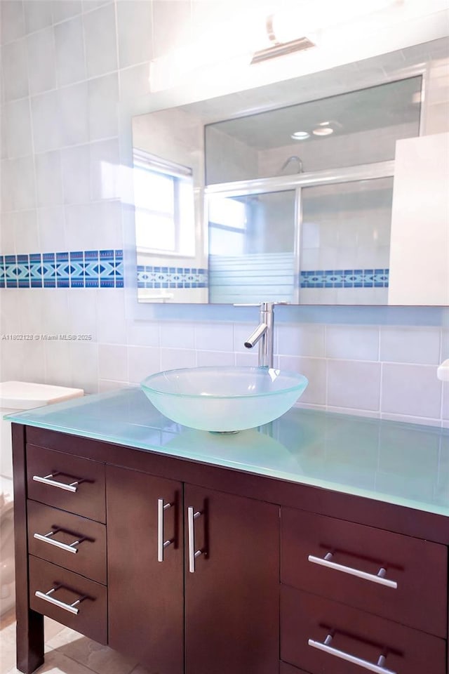 1911 NE 206th Ter, Miami, FL 33179 - bathroom with vanity, decorative backsplash, a stall shower, and tile walls