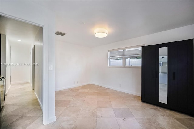 1911 NE 206th Ter, Miami, FL 33179 - spare room featuring light tile patterned floors and baseboards