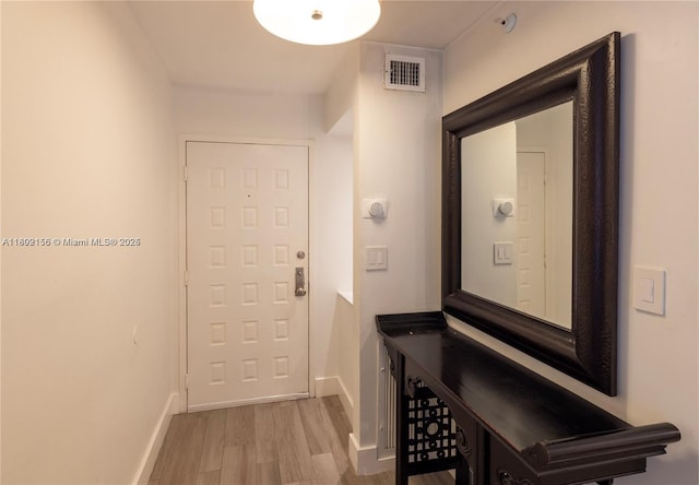6061 Collins Ave Unit 7D, Miami Beach, FL 33140 - entryway featuring wood finished floors and baseboards