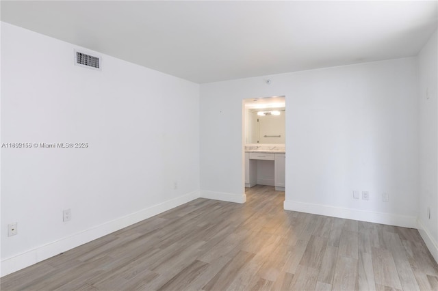 6061 Collins Ave Unit 7D, Miami Beach, FL 33140 - empty room with light wood-style flooring and baseboards