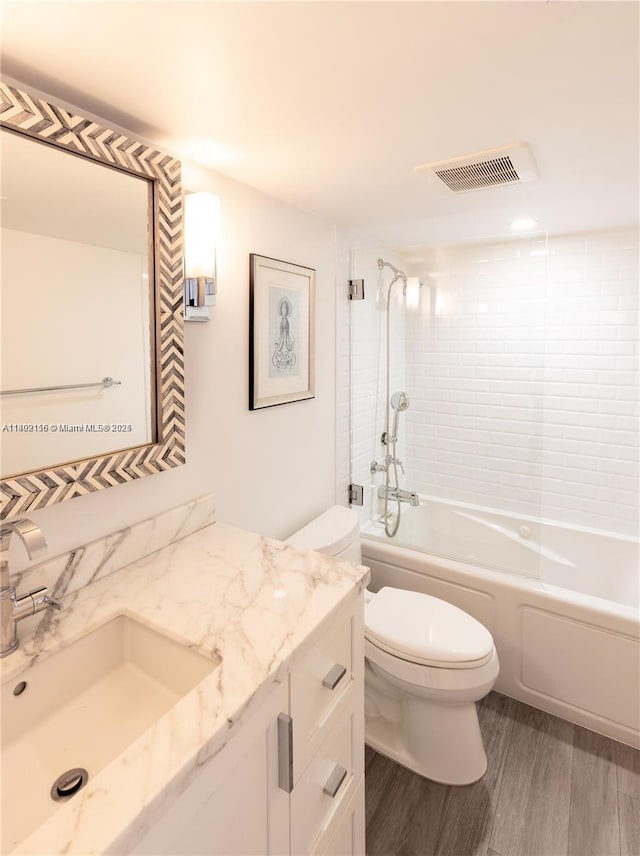 6061 Collins Ave Unit 7D, Miami Beach, FL 33140 - full bathroom with toilet, bathing tub / shower combination, wood finished floors, and vanity