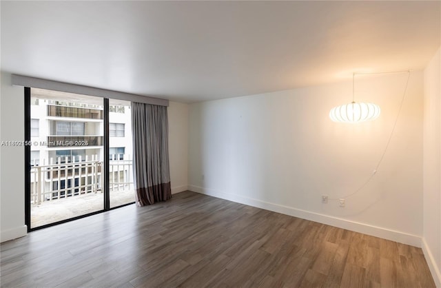 6061 Collins Ave Unit 7D, Miami Beach, FL 33140 - empty room with wood finished floors and baseboards