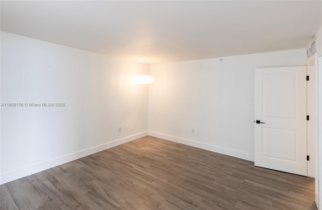 6061 Collins Ave Unit 7D, Miami Beach, FL 33140 - spare room featuring wood finished floors and baseboards