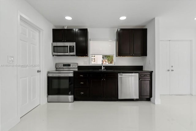 1910 NW 36th St, Oakland Park, FL 33309 - kitchen featuring stainless steel appliances, dark countertops, a sink, and recessed lighting
