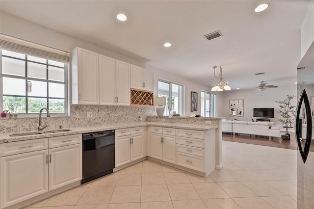 2521 Hunters Run Way, Weston, FL 33327 - kitchen with black appliances, decorative backsplash, white cabinetry, light countertops, and a chandelier
