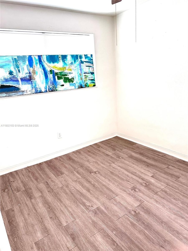 8761 NW 12th St, Pembroke Pines, FL 33024 - empty room featuring wood finished floors and baseboards
