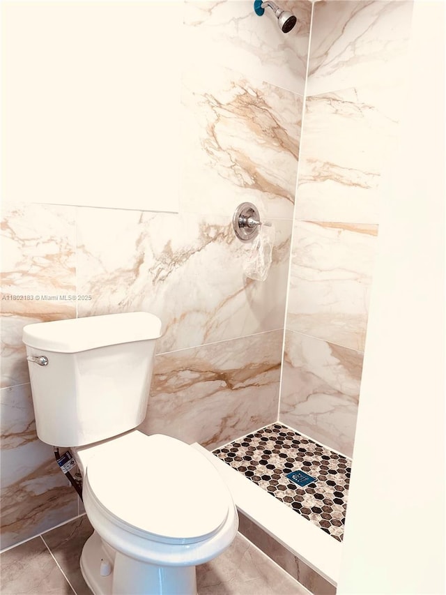 8761 NW 12th St, Pembroke Pines, FL 33024 - bathroom with a stall shower, toilet, tile walls, and marble finish flooring