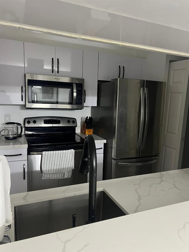 17150 N Bay Rd Unit 2218, Sunny Isles Beach, FL 33160 - kitchen featuring stainless steel appliances and light stone counters