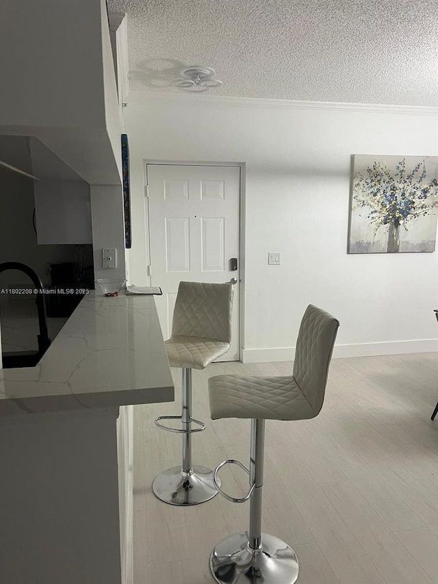 17150 N Bay Rd Unit 2218, Sunny Isles Beach, FL 33160 - dining space featuring a textured ceiling and wood finished floors