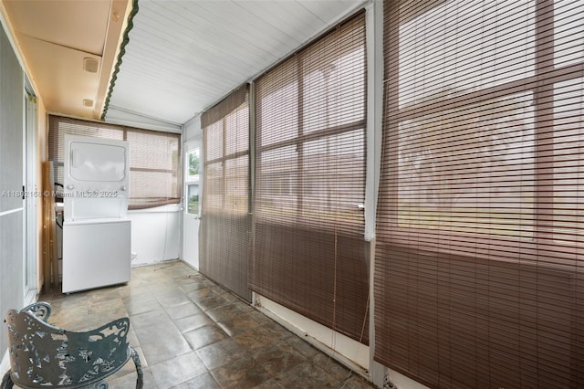 unfurnished sunroom featuring estacked washer and dryer
