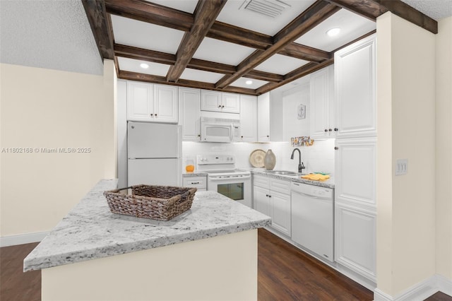 kitchen with white appliances, beam ceiling, tasteful backsplash, a sink, and dark wood-style flooring