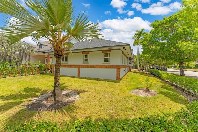 2898 SW 2nd Ave, Miami, FL 33129 - view of home's exterior featuring stucco siding, a yard, and roof with shingles