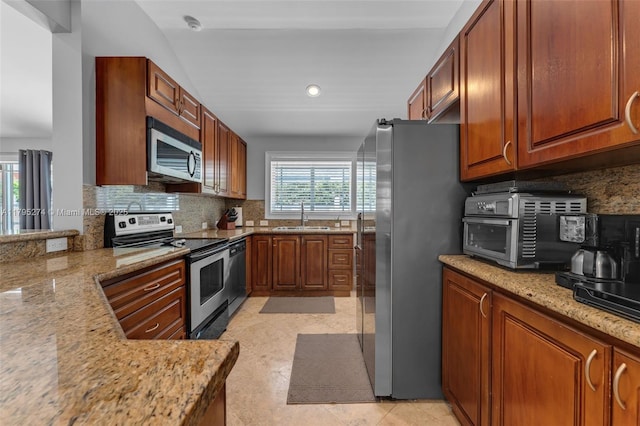 2898 SW 2nd Ave, Miami, FL 33129 - kitchen with stainless steel appliances, a sink, backsplash, light stone countertops, and recessed lighting