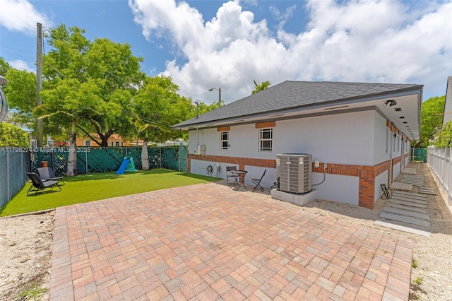 2898 SW 2nd Ave, Miami, FL 33129 - back of property featuring central AC, a patio, a shingled roof, and stucco siding