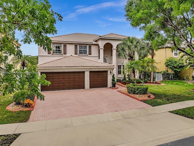 4960 SW 158th Ave, Miramar, FL 33027 - mediterranean / spanish home featuring decorative driveway, stucco siding, a tile roof, and a front yard