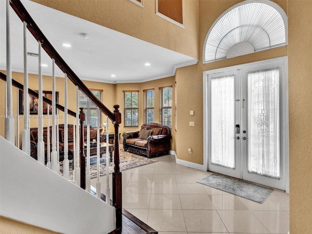 4960 SW 158th Ave, Miramar, FL 33027 - entrance foyer with french doors, a textured wall, light tile patterned floors, ornamental molding, and stairs