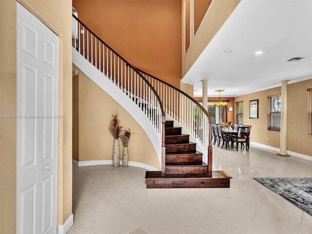 4960 SW 158th Ave, Miramar, FL 33027 - stairway with decorative columns, a chandelier, and ornamental molding