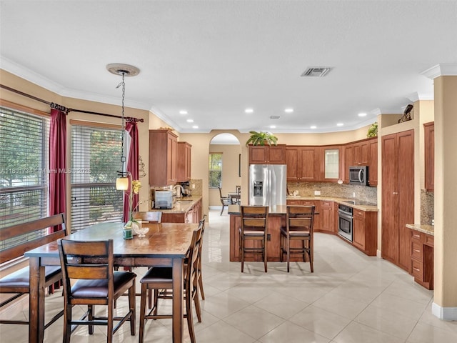 4960 SW 158th Ave, Miramar, FL 33027 - dining space featuring ornamental molding, plenty of natural light, recessed lighting, arched walkways, and light tile patterned floors