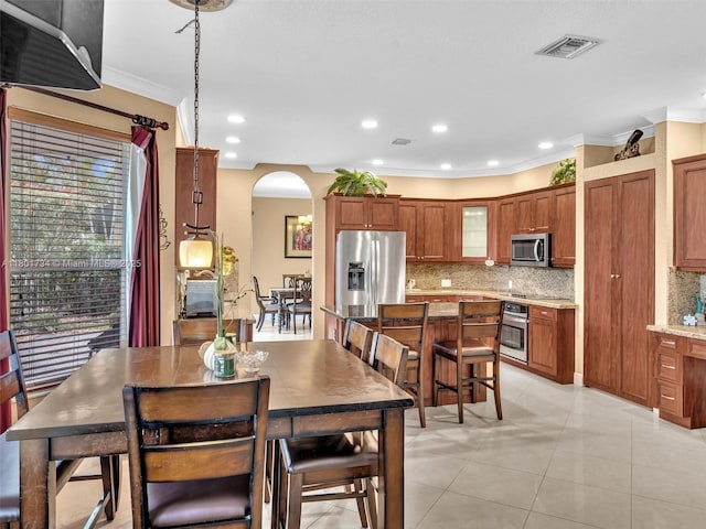 4960 SW 158th Ave, Miramar, FL 33027 - dining space featuring arched walkways, ornamental molding, light tile patterned flooring, and recessed lighting