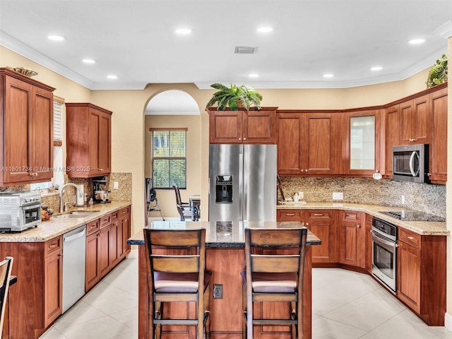 4960 SW 158th Ave, Miramar, FL 33027 - kitchen with stainless steel appliances, light tile patterned flooring, backsplash, light stone countertops, and recessed lighting