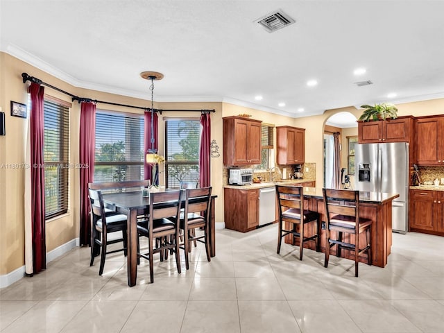 4960 SW 158th Ave, Miramar, FL 33027 - dining room featuring crown molding, arched walkways, and recessed lighting