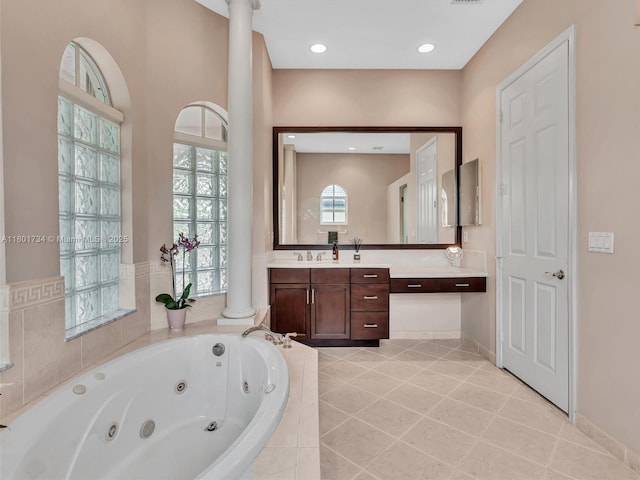 4960 SW 158th Ave, Miramar, FL 33027 - bathroom featuring ornate columns, a whirlpool tub, vanity, and tile patterned flooring