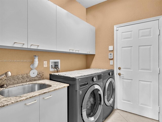 4960 SW 158th Ave, Miramar, FL 33027 - laundry room featuring cabinet space, washing machine and clothes dryer, light tile patterned floors, and a textured wall