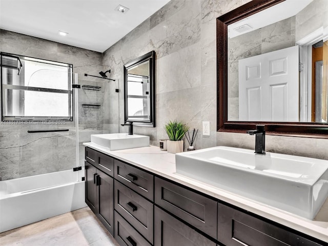 4960 SW 158th Ave, Miramar, FL 33027 - bathroom featuring tile walls, double vanity, and washtub / shower combination